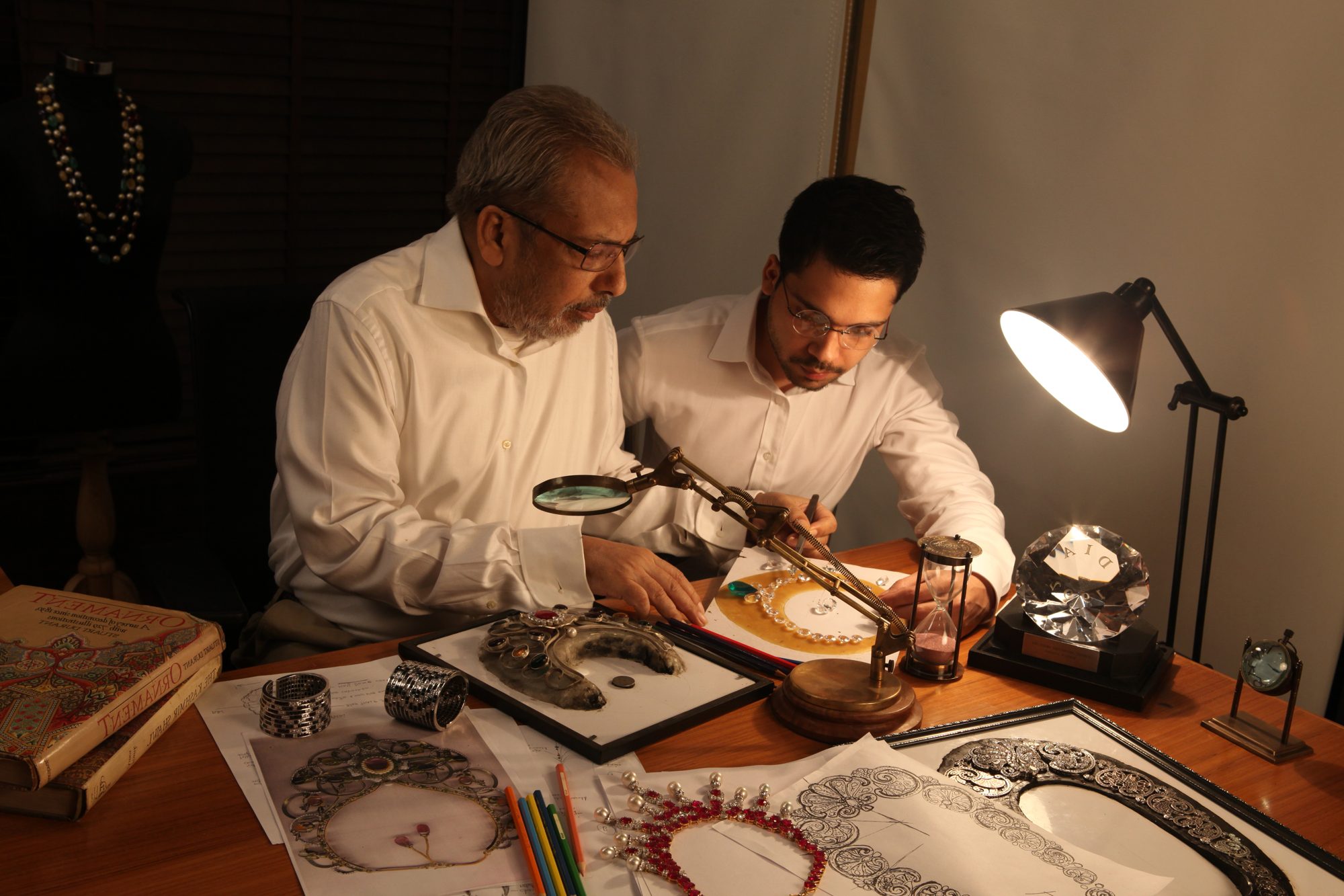 Nipun Khanna working at the design table with a senior craftsman