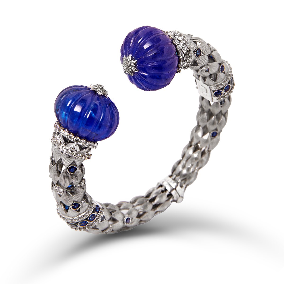 White gold bangle with tanzanite melon ends and diamonds