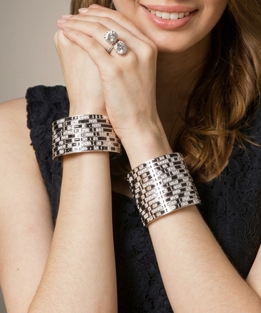 Pair of wide diamond and black enamel cuffs worn on both wrists